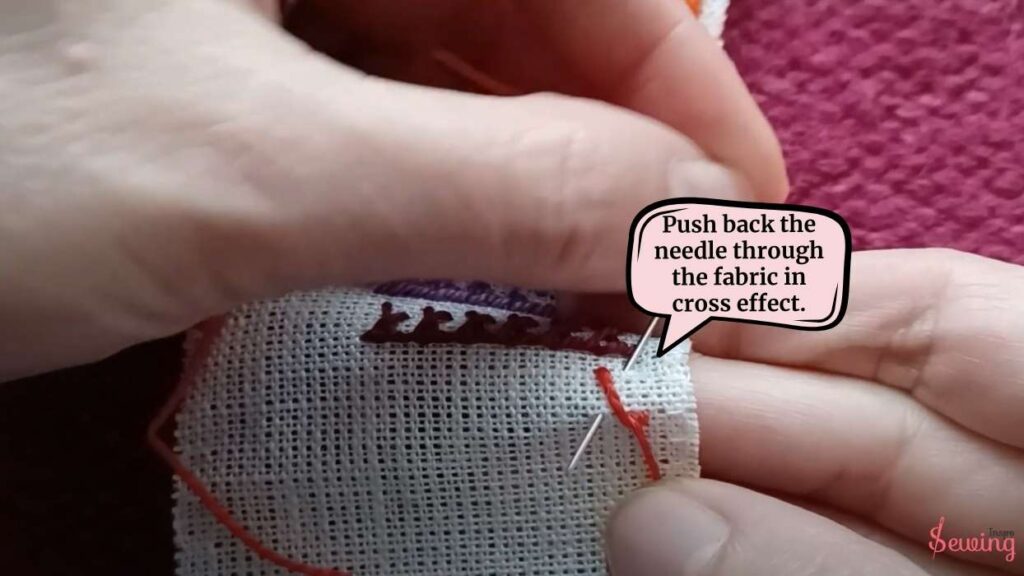 Push back the needle through the fabric in cross effect