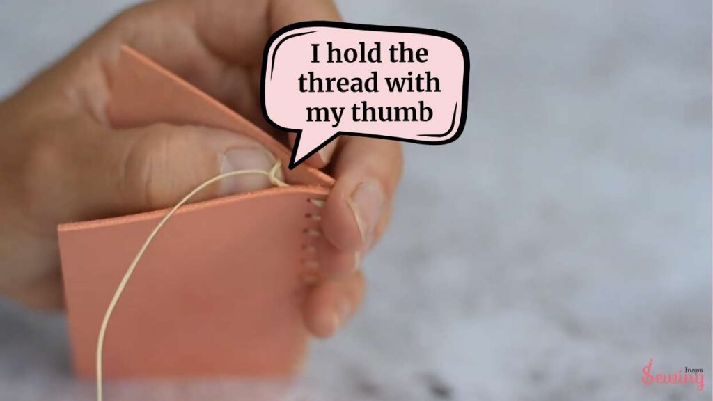 I hold the thread with my thumb