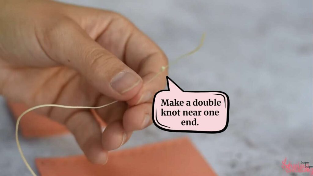 Make a double knot near one end