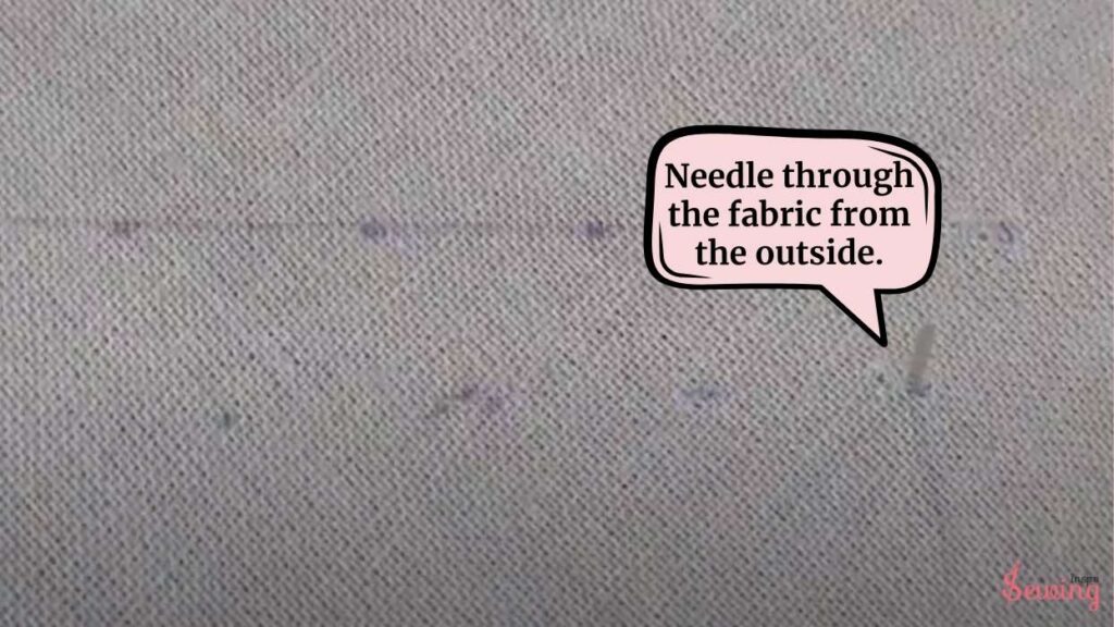 needle through the fabric from the outside