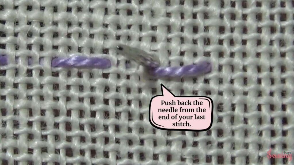 Push back the needle from the end of your last stitch