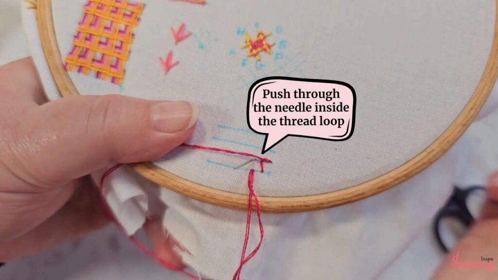 push through the needle inside the thread loop