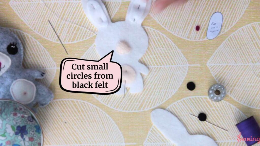 cut small circles from black felt