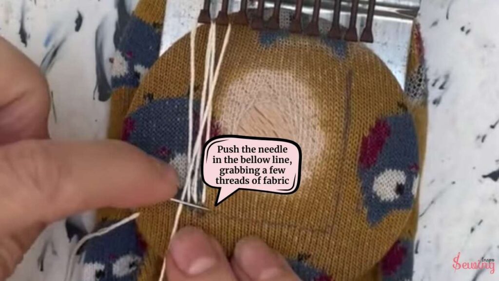 push the needle in the bellow line, grabbing a few threads of fabric