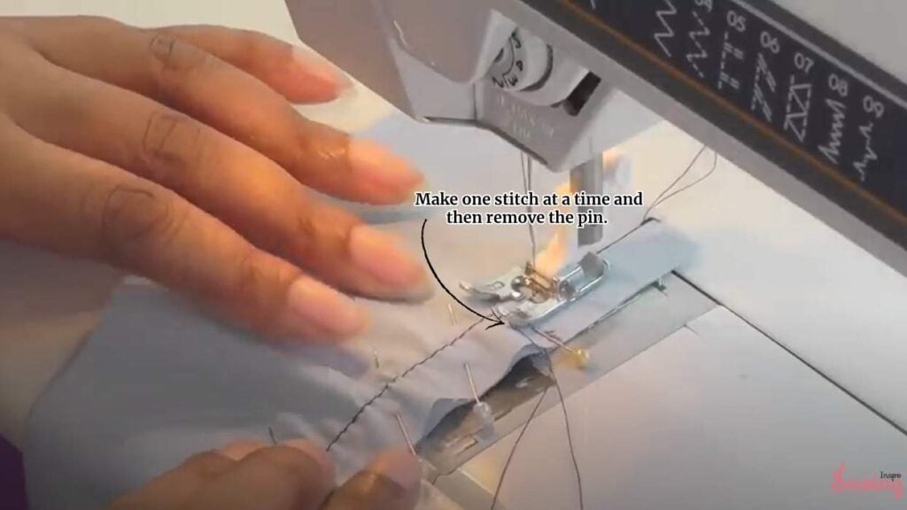 Make one stitch at a time, and then remove the pin