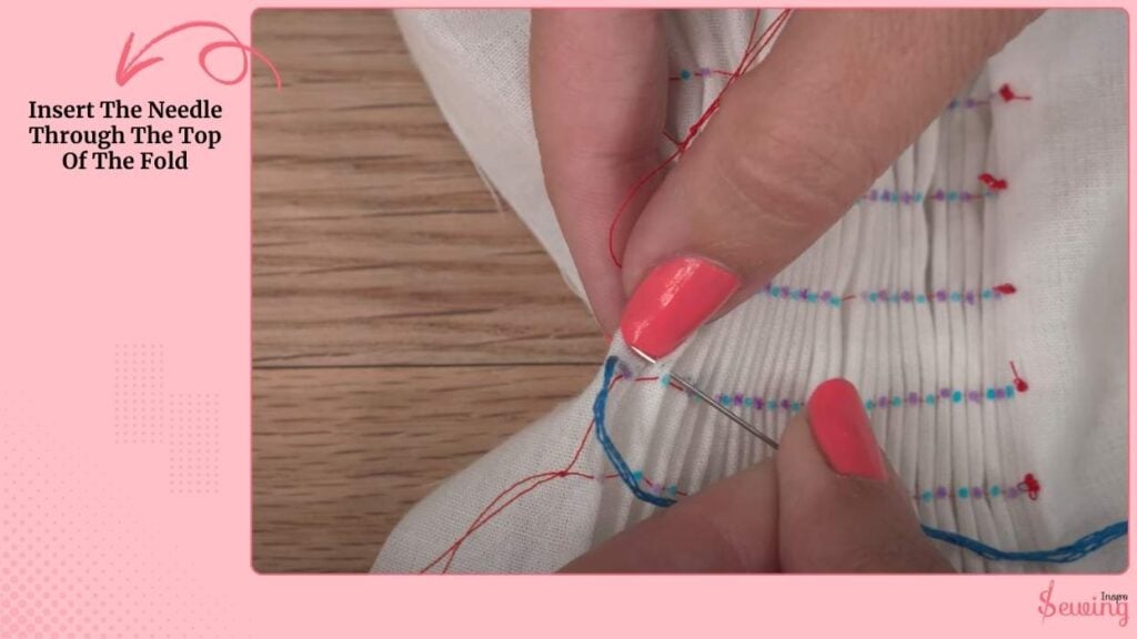 Insert The Needle Through The Top Of The Fold